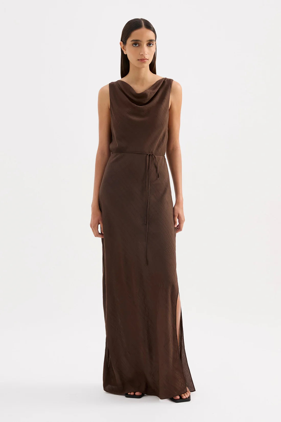 Woman wearing a brown sleeveless dress on a white background