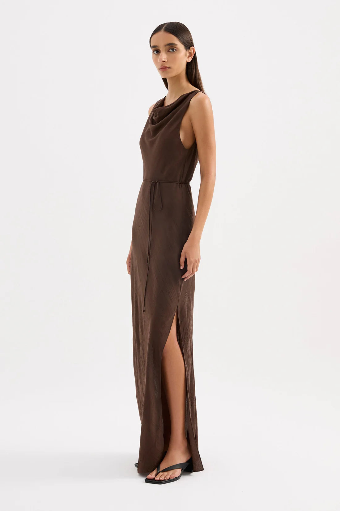 Woman wearing a brown evening gown on a white background