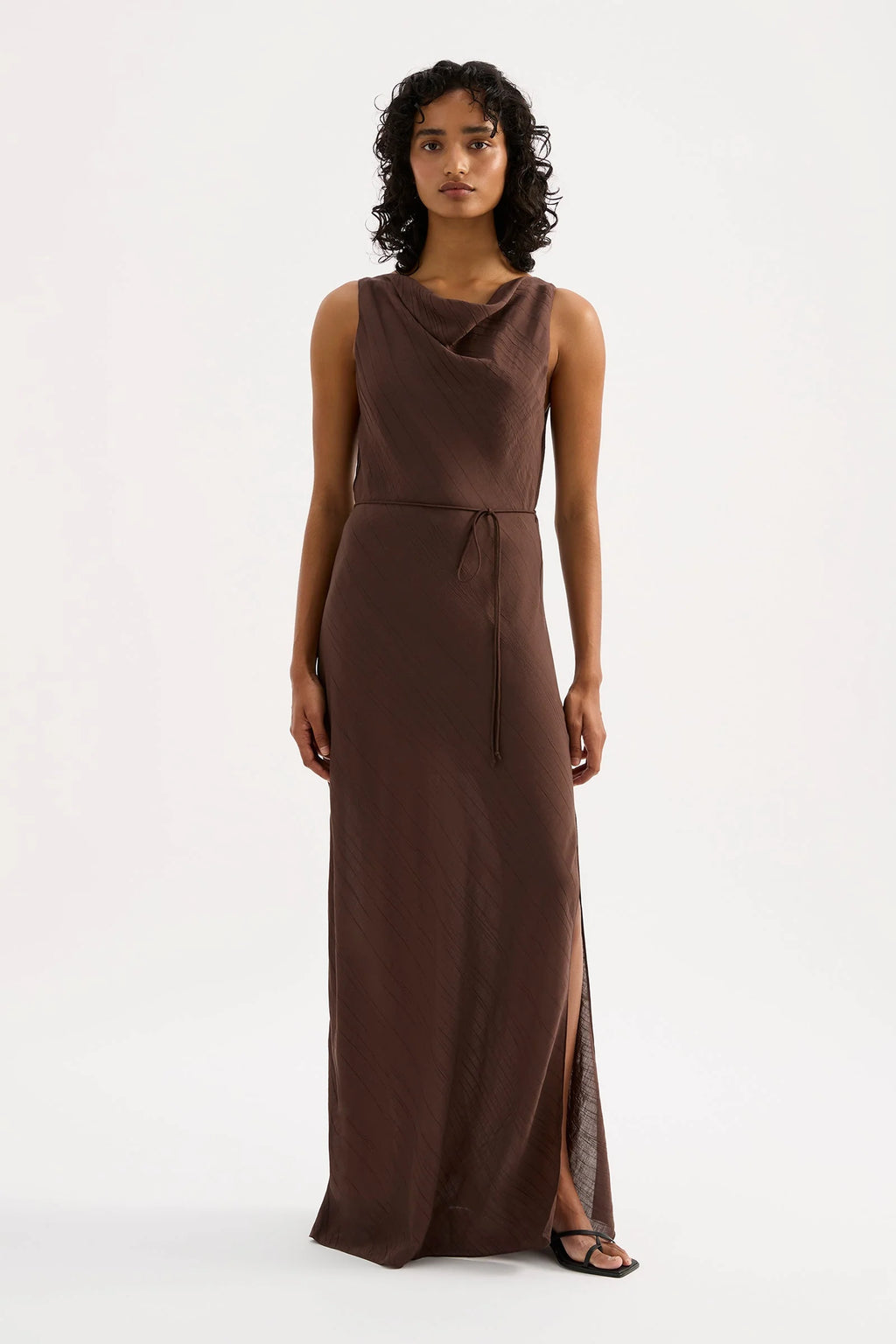 Woman wearing a brown sleeveless dress on a white background