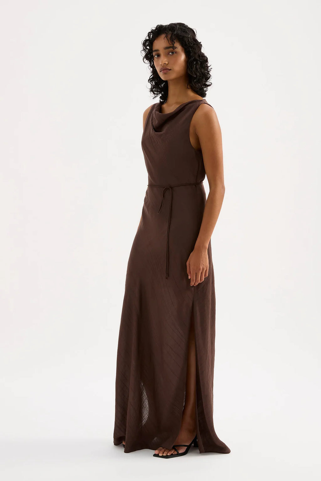 Woman wearing a brown sleeveless dress on a white background
