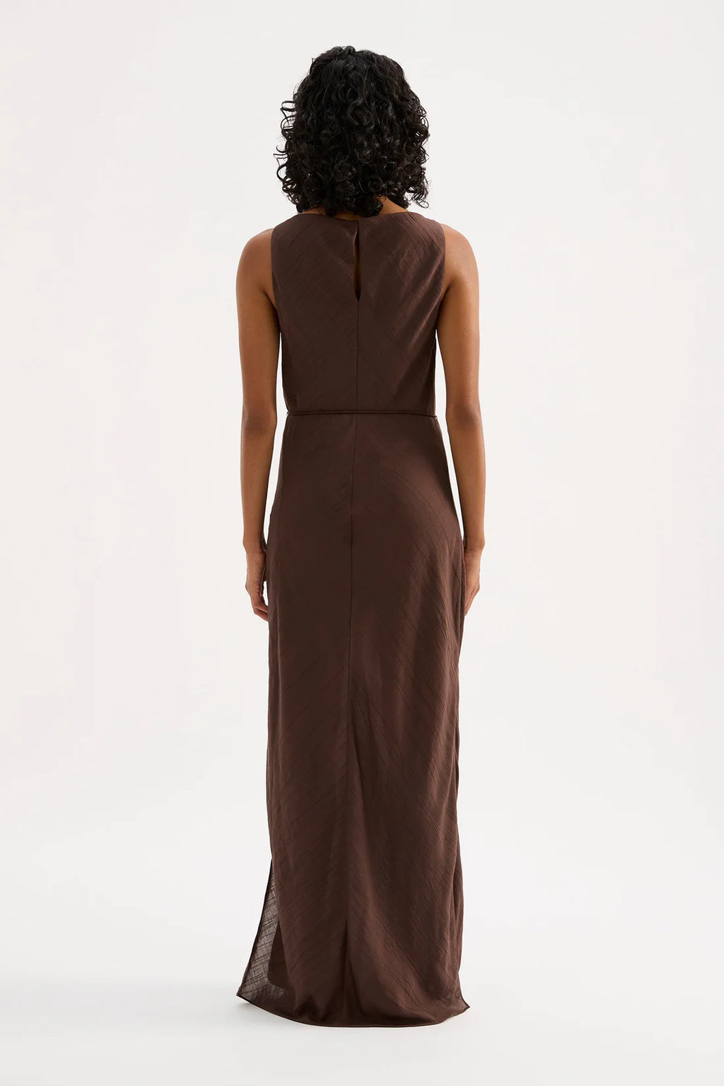 Woman wearing a brown dress on a white background