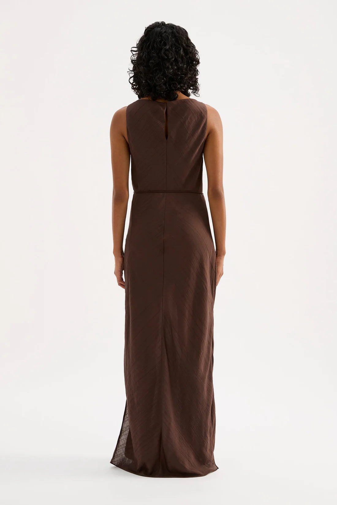 Woman wearing a brown dress on a white background